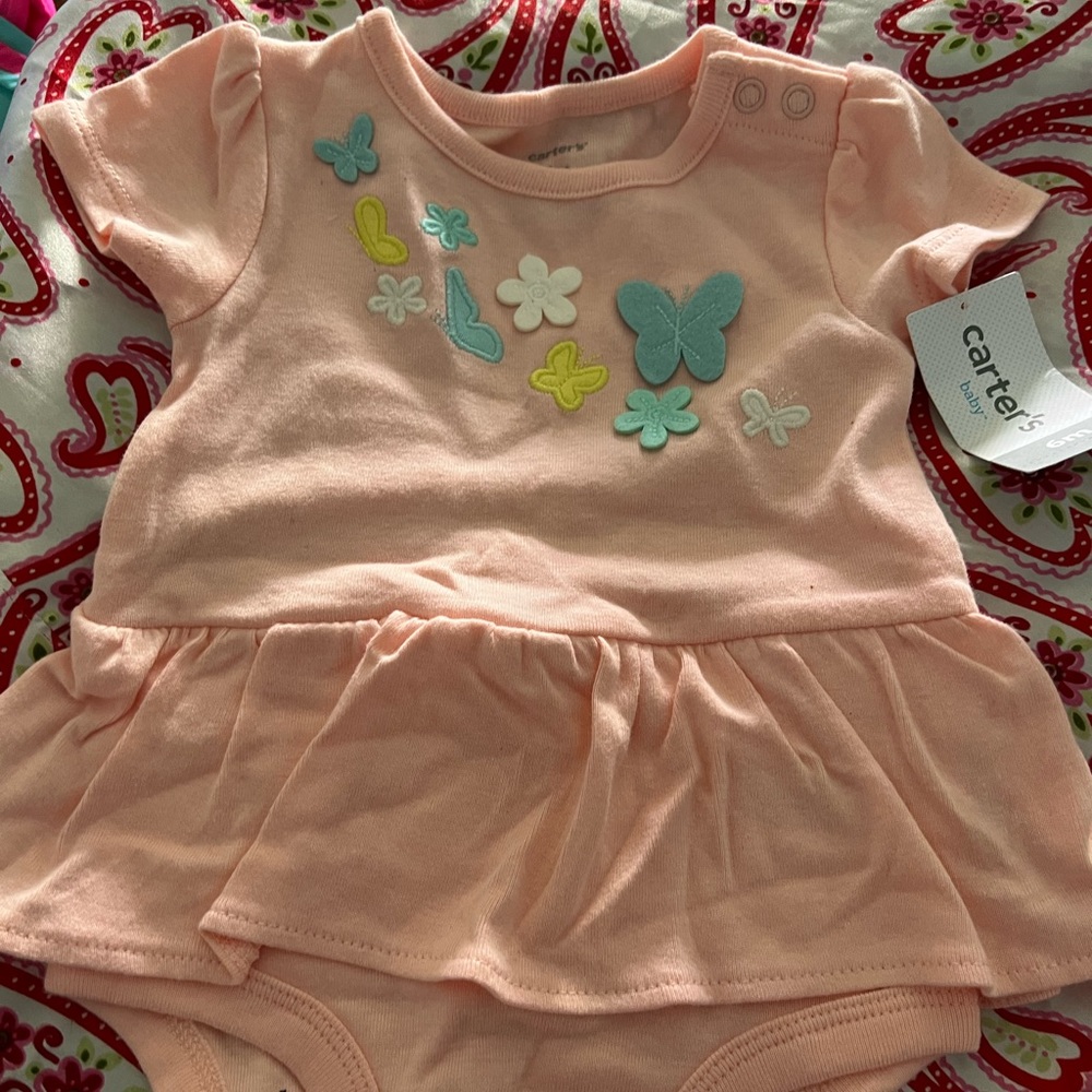 This is a Carter's light pink one piece that fits a 6 month old.